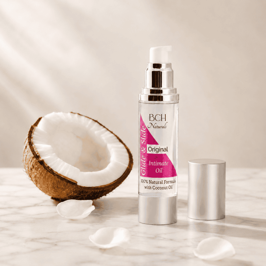 Coconut Oil Lubricant and a half coconut with white rose petals on marble