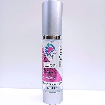 BCH Naturals coconut intimate oil in a glass pump bottle, placed on a bedside table for a discreet, calming nighttime ritual