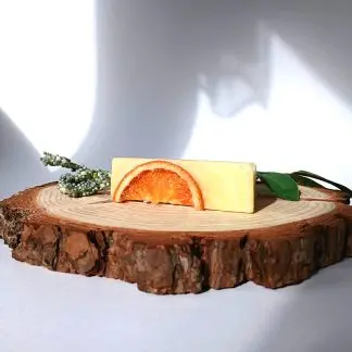 Orange Soap Bar on top of a slice of wood