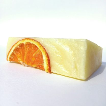 Close-up of Orange Serene artisan soap bar showing beautiful texture and citrus detailing, enriched with uplifting essential oils