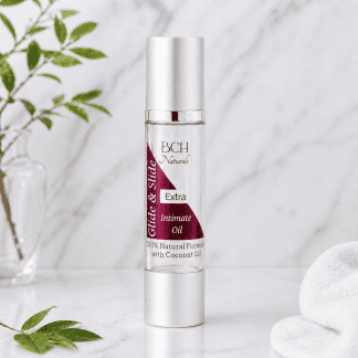 BCH Naturals Slide & Glide Extra Intimate Oils pleasure oils in marble surround with spa towel