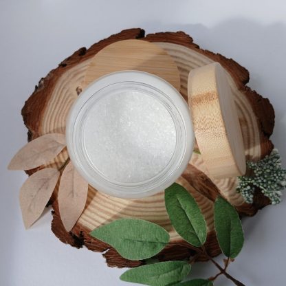 jar of bath salts on a slice of wood