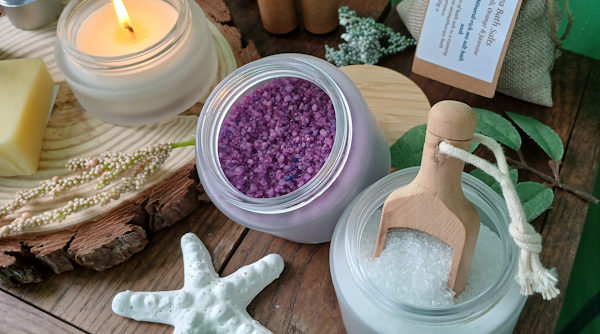 A Candle, a bath soak, and a starfish on a bathroom sideboard