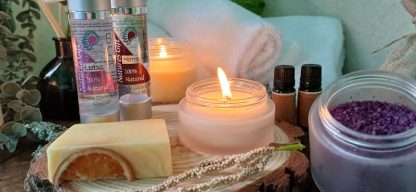Spa scene with lite candles, Glide oils and soap with essential oils