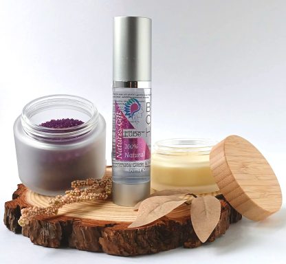 Bath Salts in a jar, with Body Glide Oil and a candle on a slice of wood