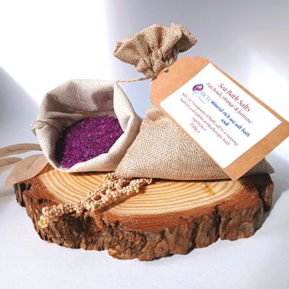 Orange Jasmine & Refill Patchouli Sea Salt in a Hemp Sack on a slice of wood with leaves