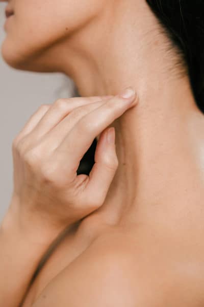 a partial side view of a lady her neck and shoulder showing only skin