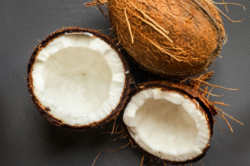 Coconut halves on a dark background