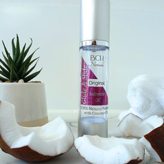 BCH Naturals Glide & Slide 100% natural coconut intimate oil displayed on white marble – with real coconut - a gentle, plant-based oil for connection and comfort