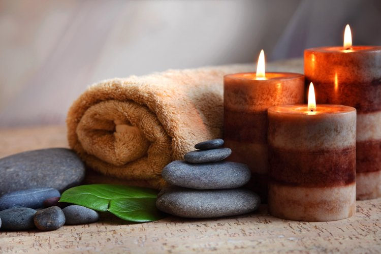 home spa night candles, towels and stones ready for massage