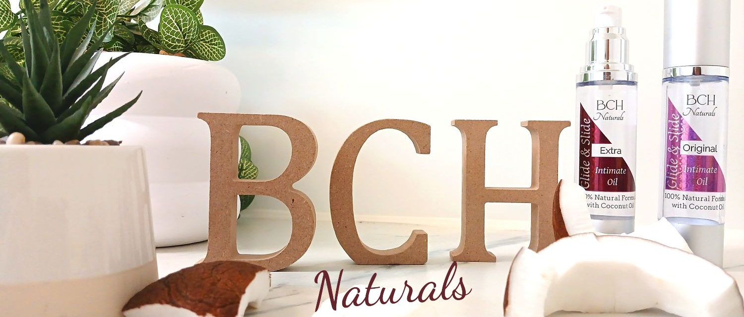 BCH Naturals coconut-based intimate oil and a halved coconut – symbolising connection, care, and natural intimacy.